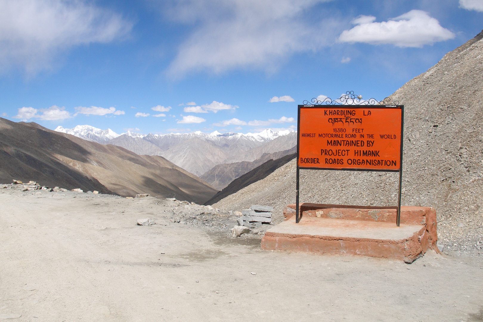 Winding high-altitude mountain pass through snow-crested Himalayan peaks in Ladakh
