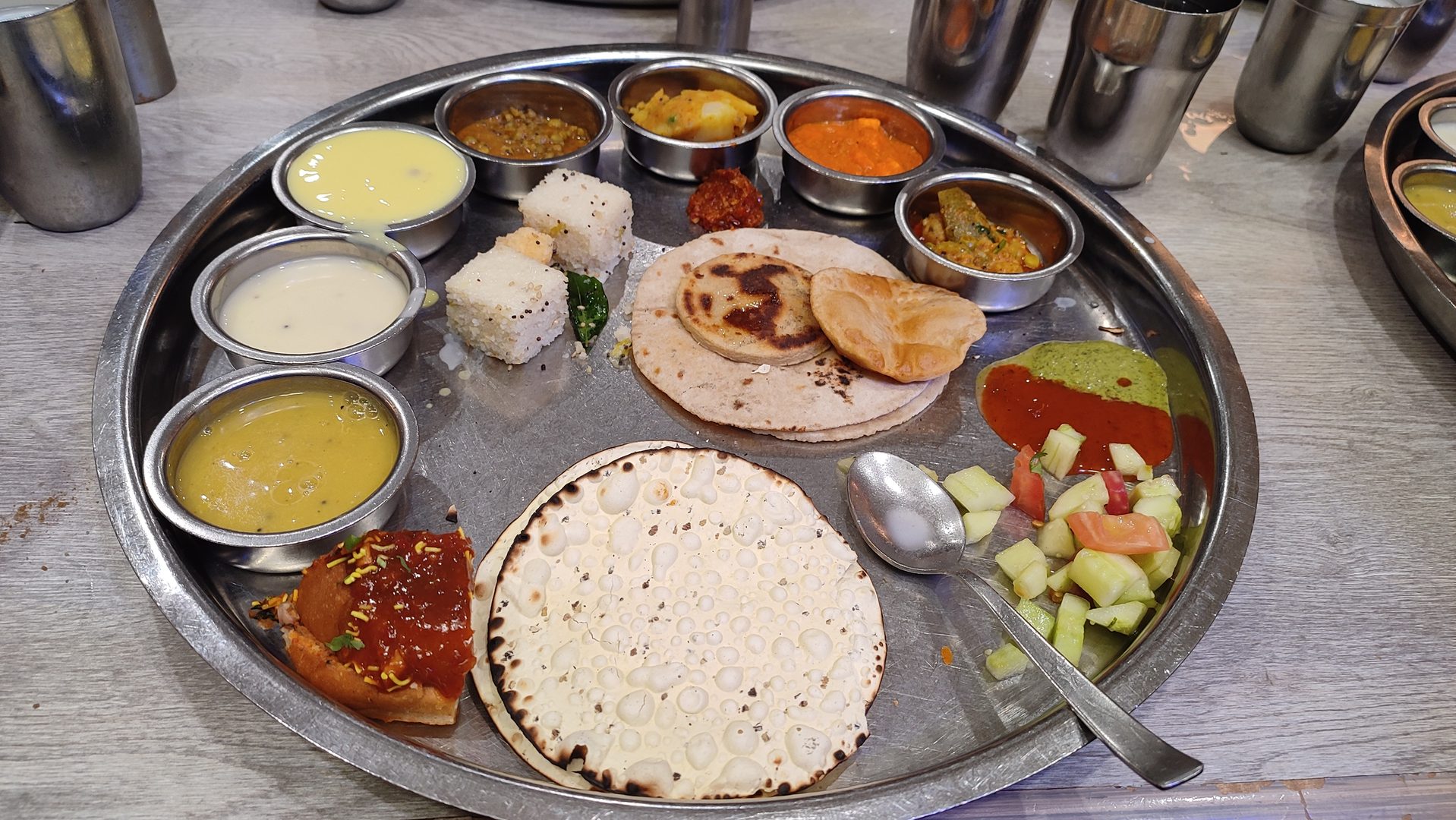 Authentic Gujarati and Rajasthani vegetarian feast with kadhi, rotli, and sweet-savory delicacies
