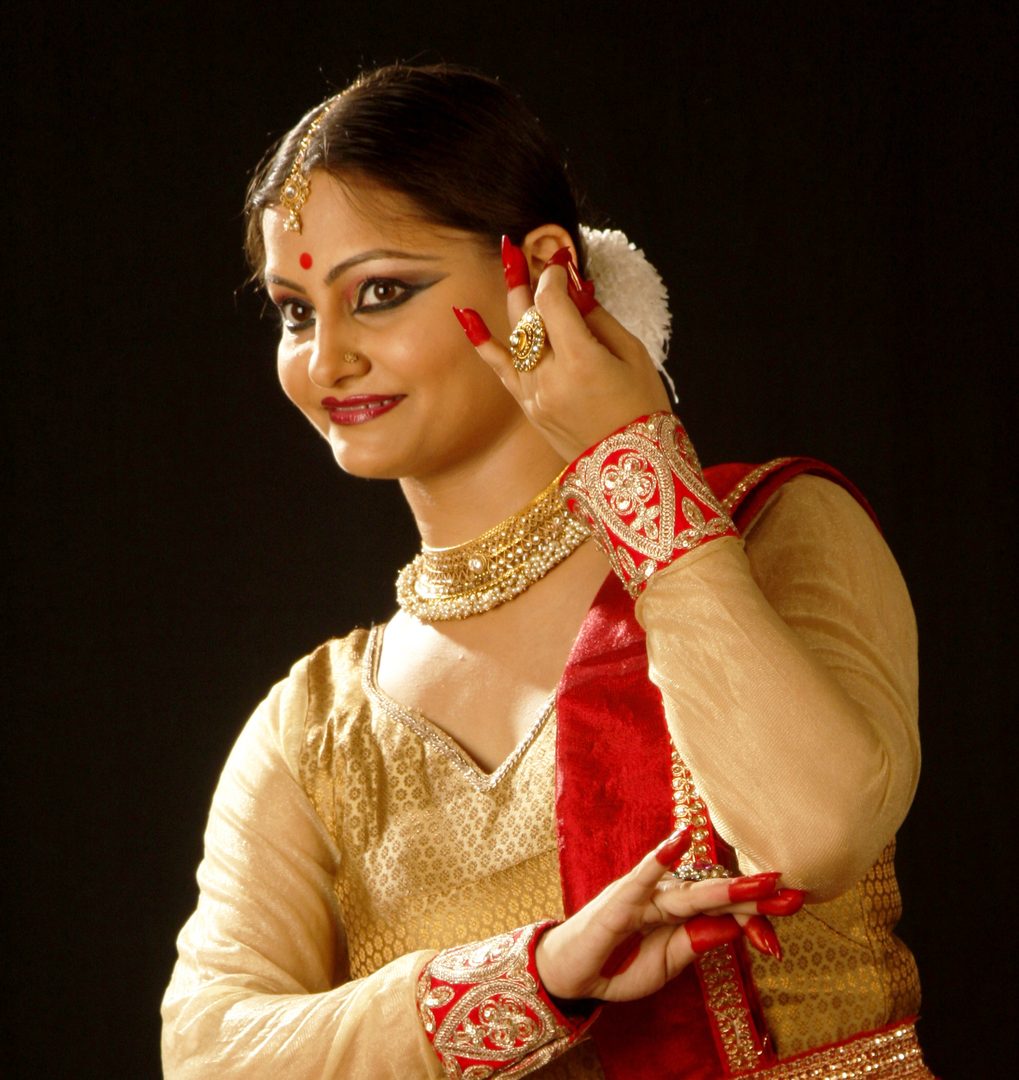 Classical Kathak dancer performing graceful rhythmic spins with ghungroos