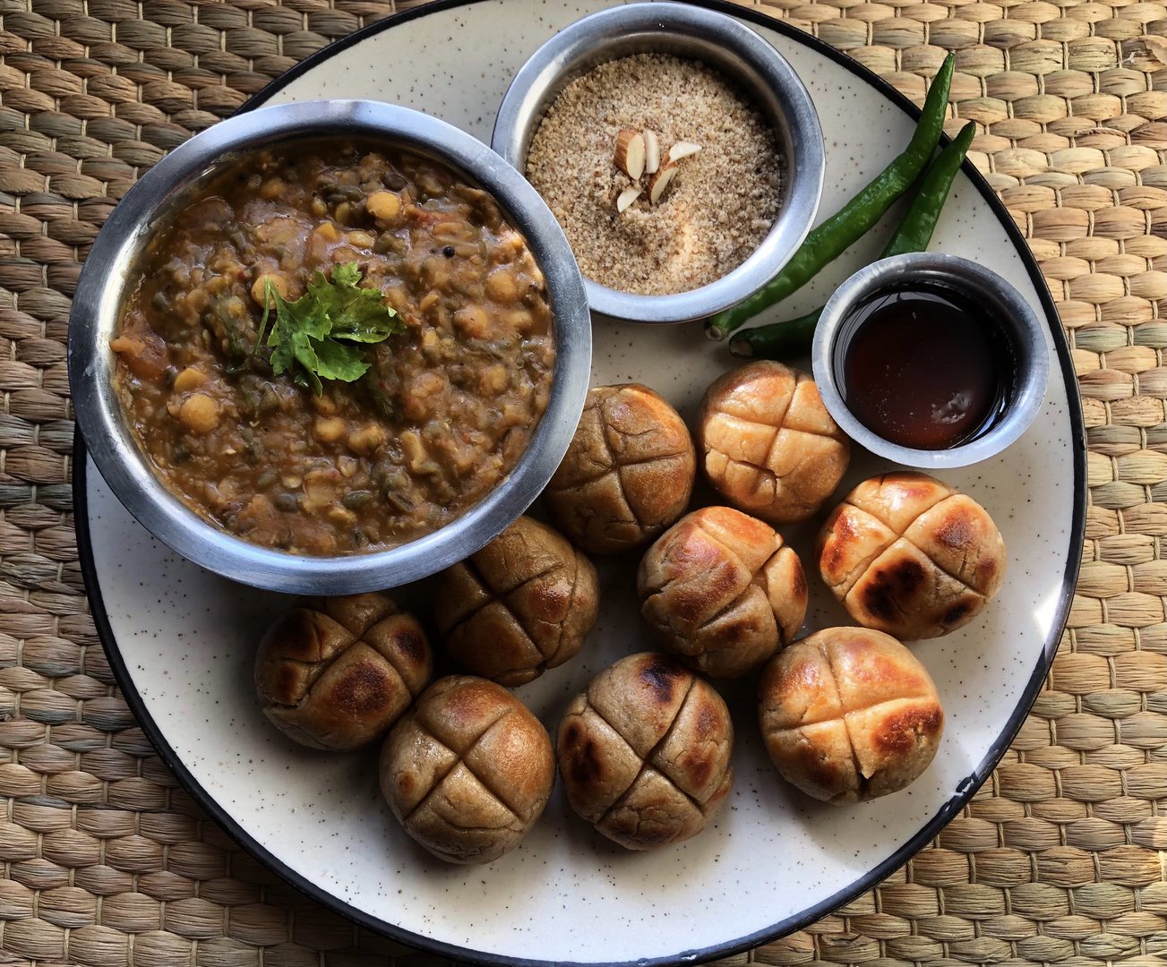Authentic traditional Rajasthani dal baati churma meal served with ghee and fresh chutneys