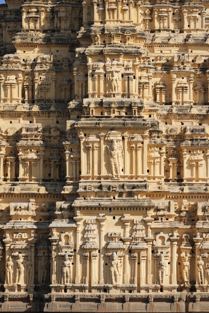 Towering stone gopuram of Virupaksha Temple reflected in the waters of Tungabhadra in Hampi