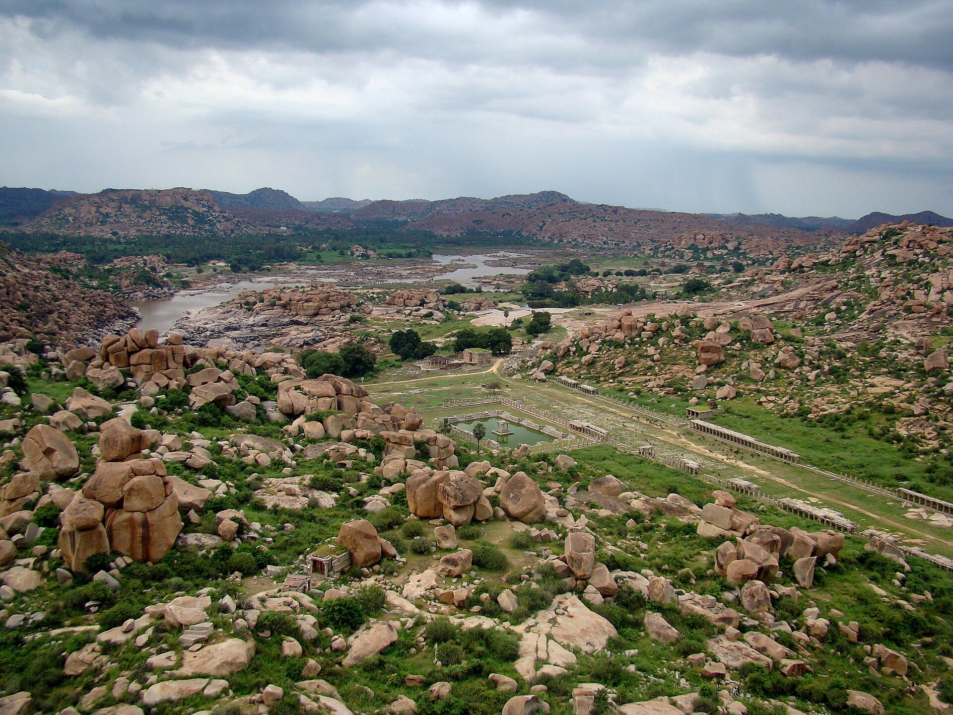 Towering primordial basalt cliffs and carved granite boulders of the Deccan