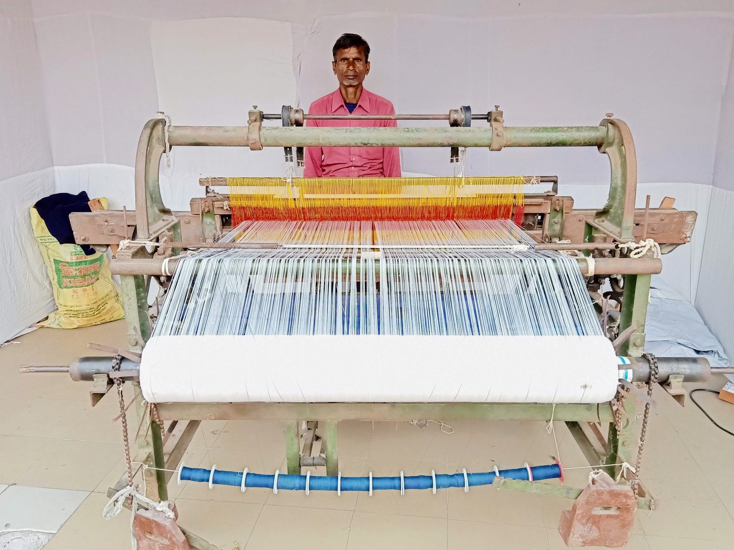Traditional craftsman spinning and weaving fine cotton handloom khadi