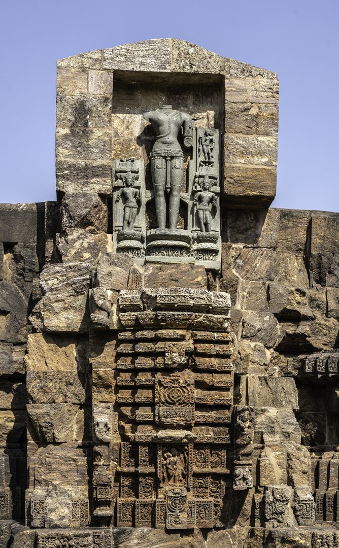 Dawn sunlight illuminating ancient stone sculptures of Konark Sun Temple in Odisha