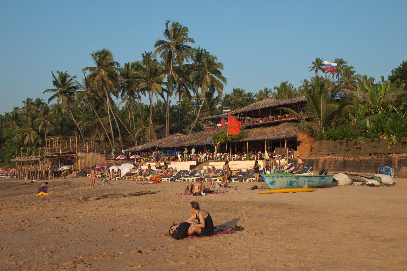 Dramatic rocky headland and golden sunset over Arabian Sea waves in Goa
