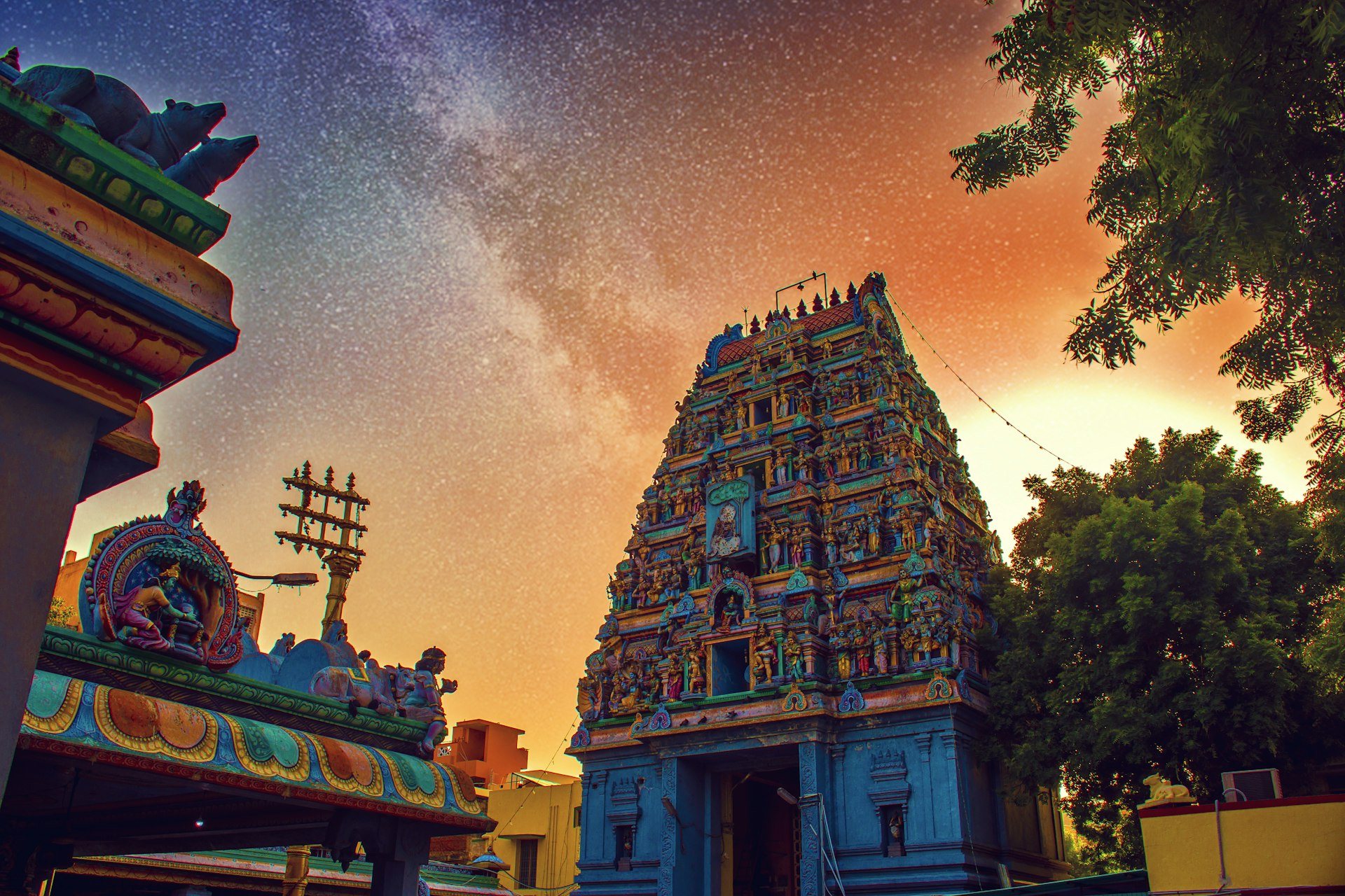 Magnificent towering Dravidian stone gopuram rising into the twilight sky in South India