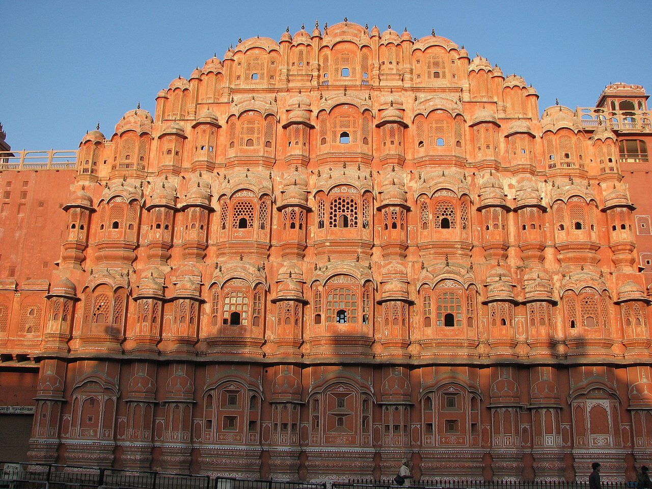 Intricate terracotta-pink sandstone facade and honeycombed jharokha windows of Hawa Mahal in Jaipur, Rajasthan
