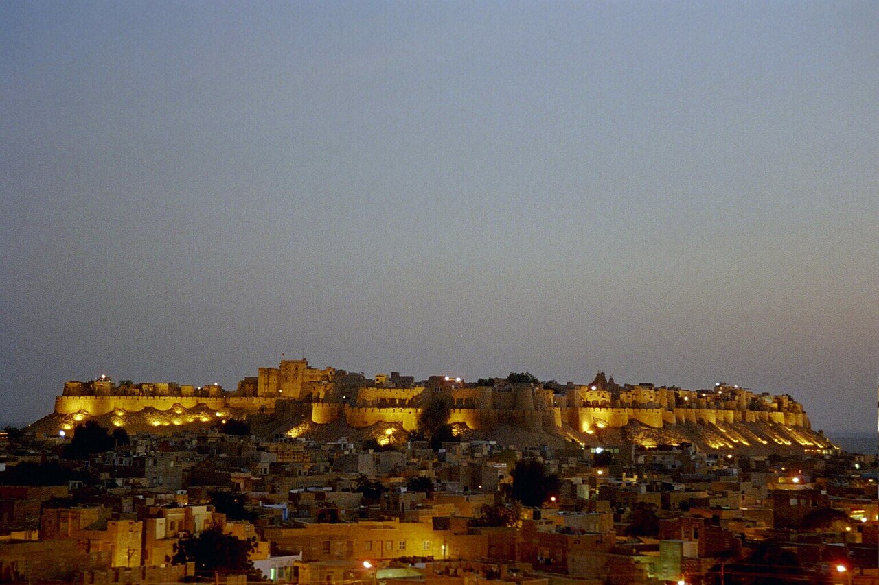 Jaisalmer Golden Fort ramparts illuminated over the desert at twilight
