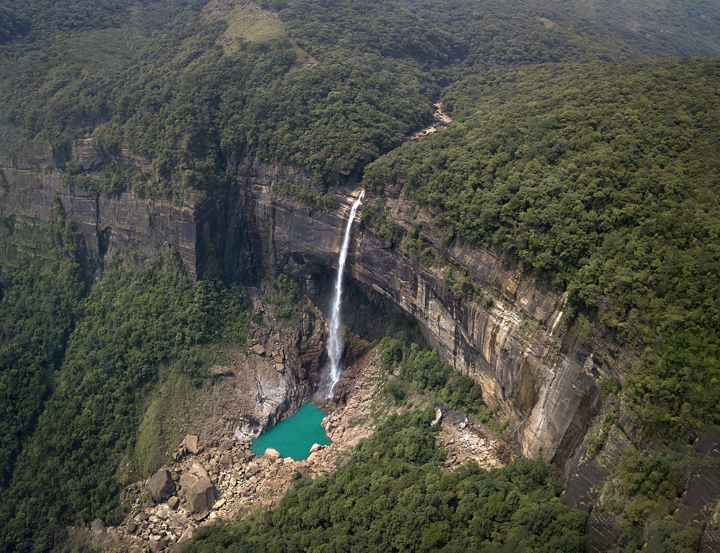 Dramatic single-drop torrent of Nohkalikai Falls plunging into emerald plunge pool in Cherrapunji, Meghalaya