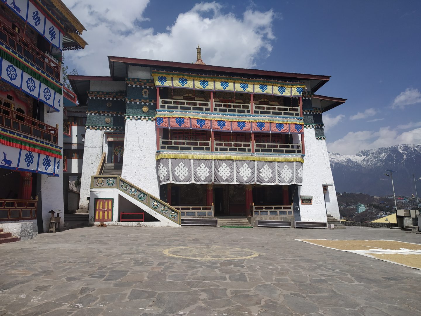 Colorful Buddhist prayer flags framing majestic Himalayan mountain peaks in Arunachal Pradesh