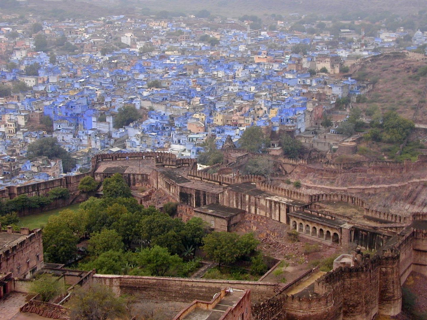 Towering cliff-top battlements and red sandstone ramparts of Mehrangarh Fort in Jodhpur