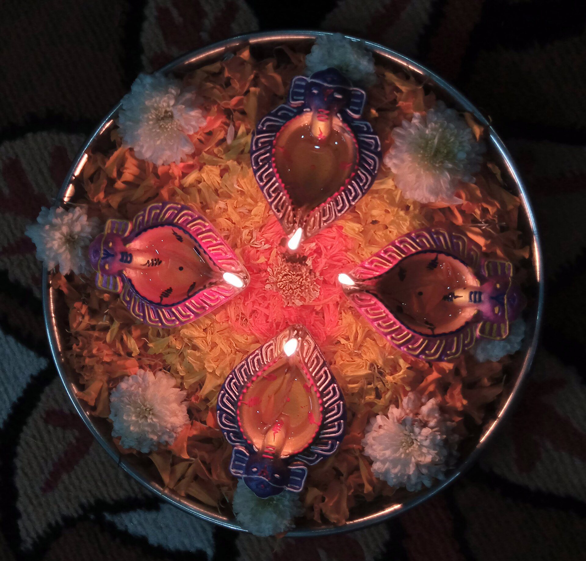 Traditional terracotta earthen diyas glowing warmly during Diwali festival of lights