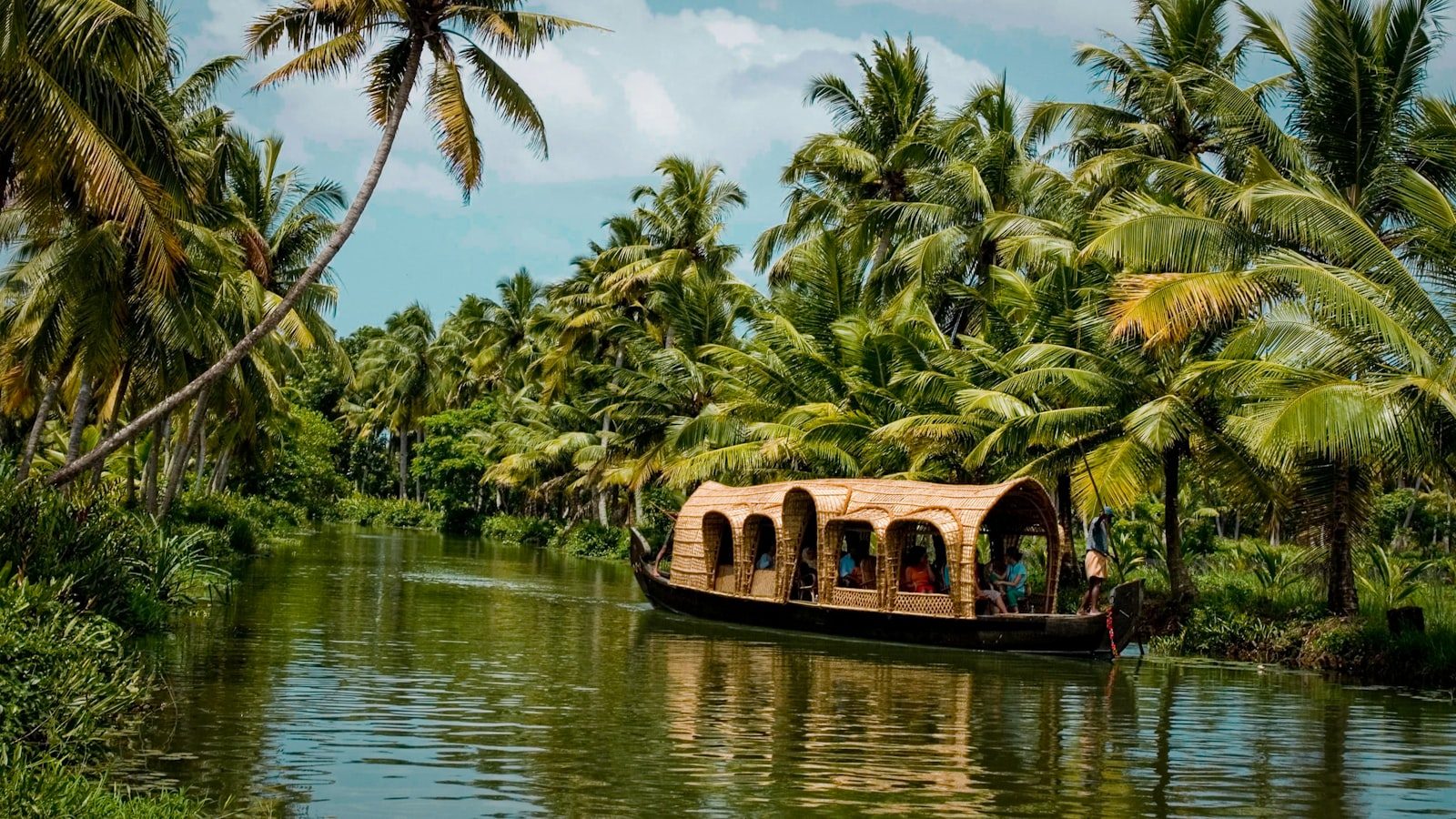 Traditional wooden canoe gliding on serene misty Kerala backwaters