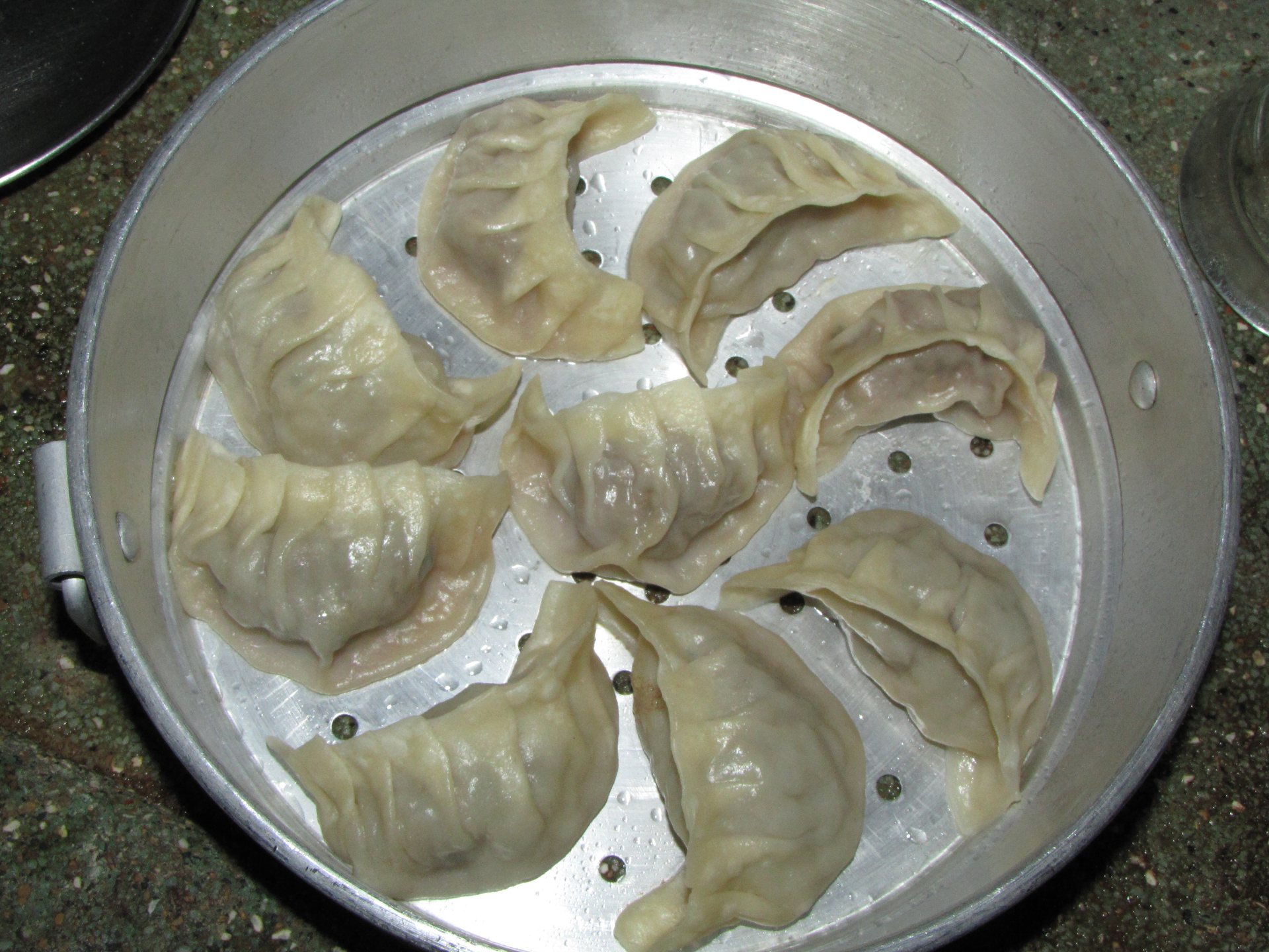 Freshly steamed hand-pinched Tibetan style momos served in bamboo steamer