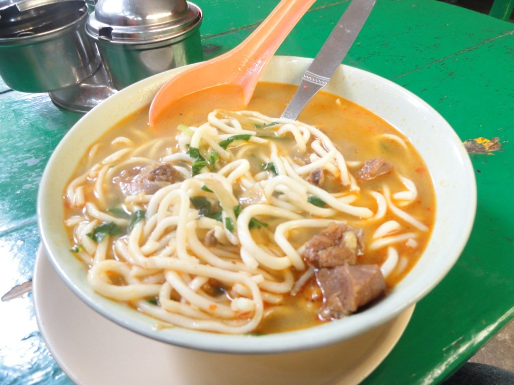 Hot steaming bowl of Himalayan vegetable noodle soup Thukpa with broth and cilantro