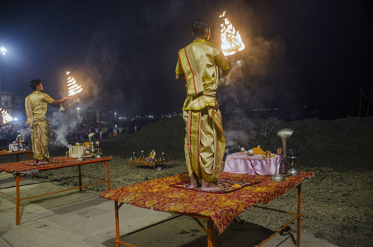 Sacred evening prayer lamps glowing warmly during subcontinental riverfront festivities