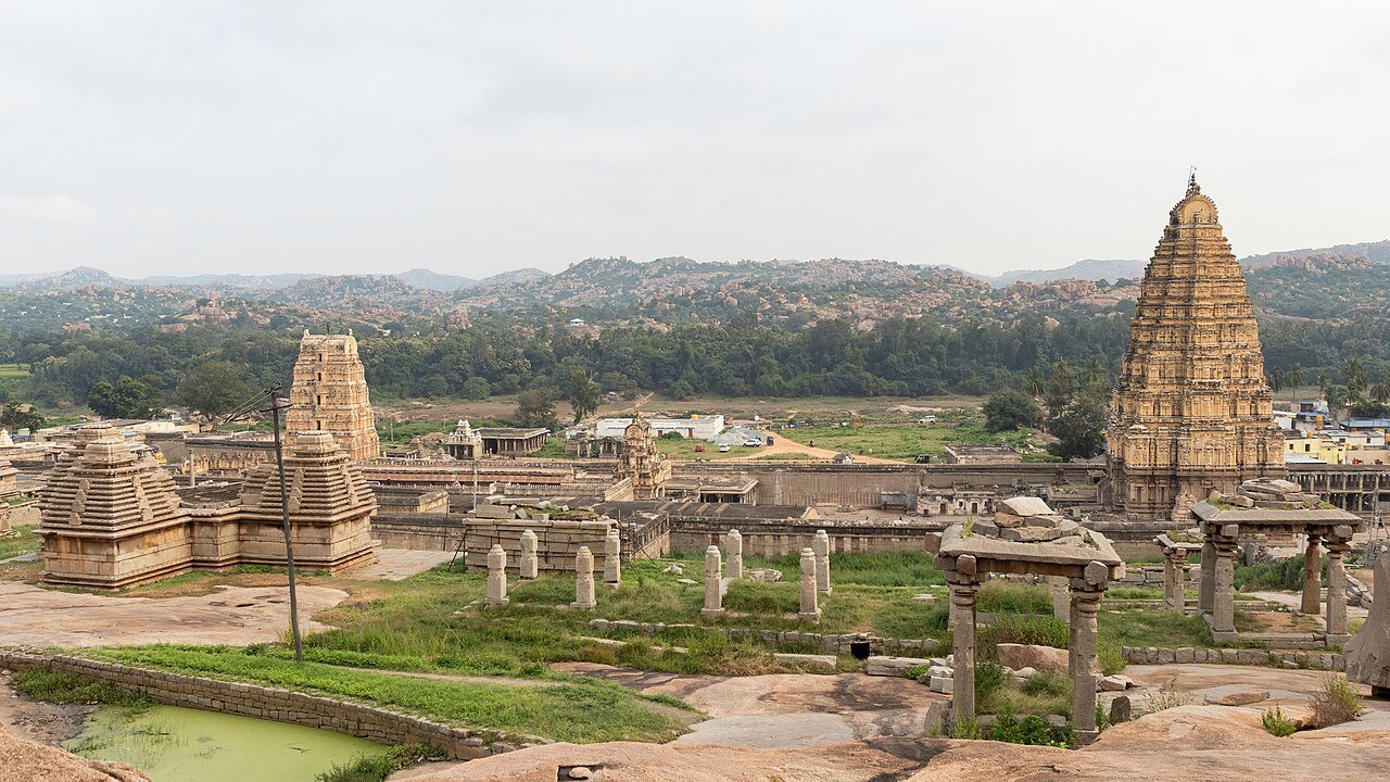 Virupaksha Temple monumental gopuram rising above the ancient granite boulder ruins of Hampi