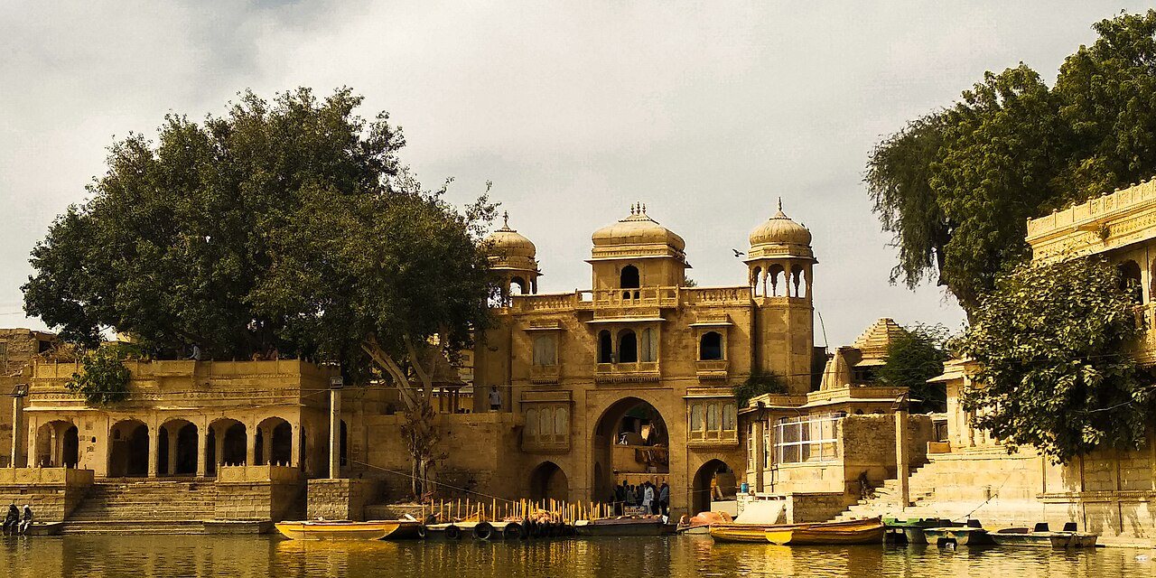 Historical stone carved chhatris and gateway over Gadsisar Lake reservoir in Jaisalmer