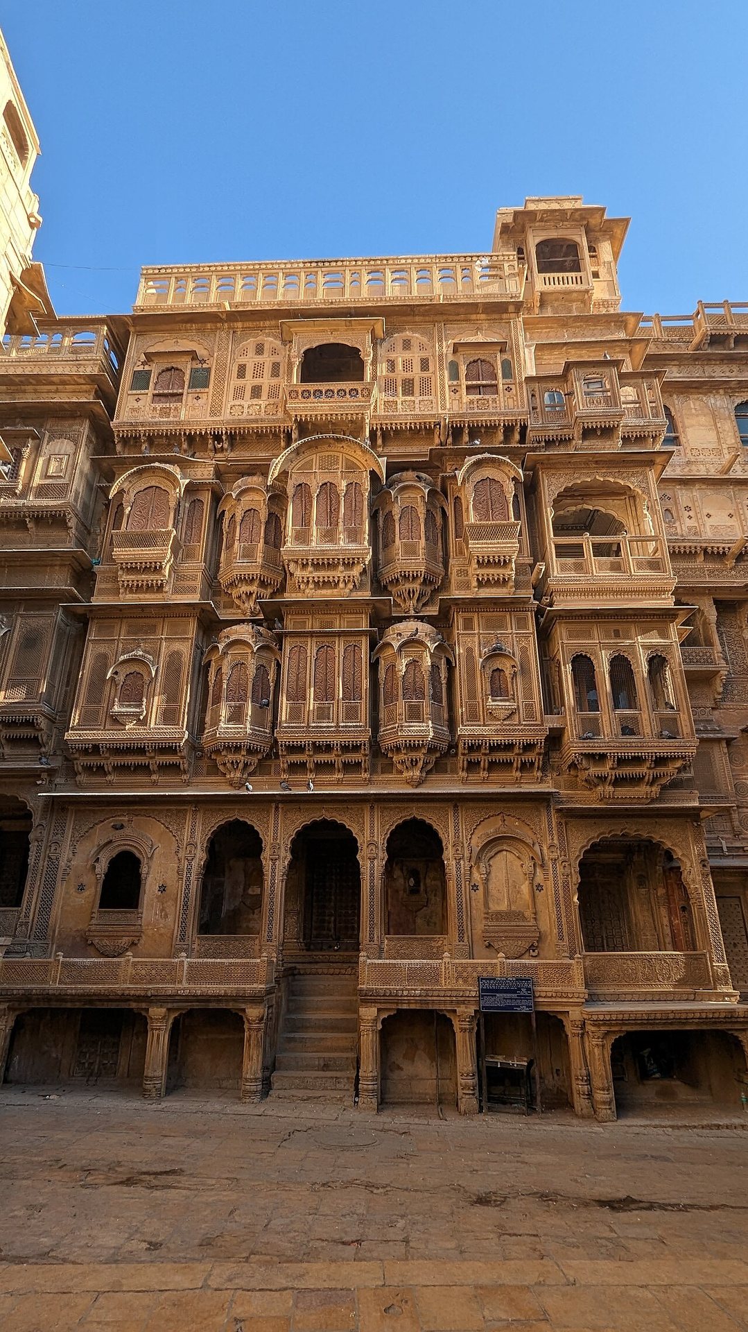 Intricate carved yellow sandstone jharokhas and latticework balconies of Patwon Ki Haveli in Jaisalmer