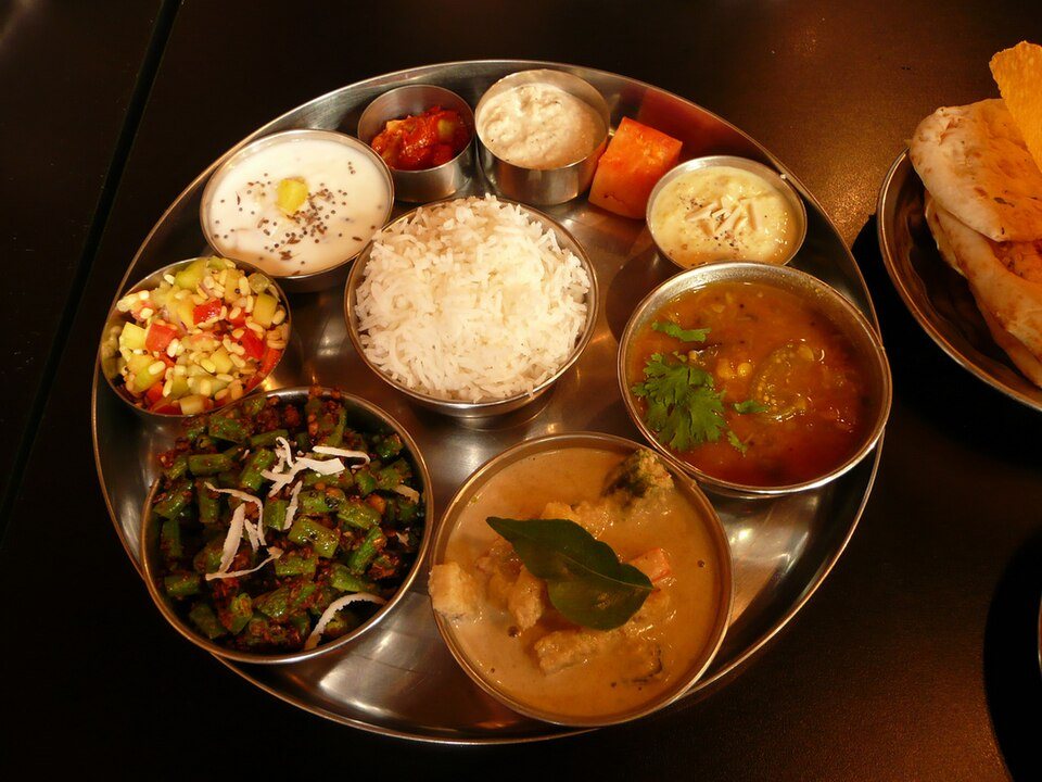 Traditional Indian thali feast with regional curries, lentils, rice, and bread