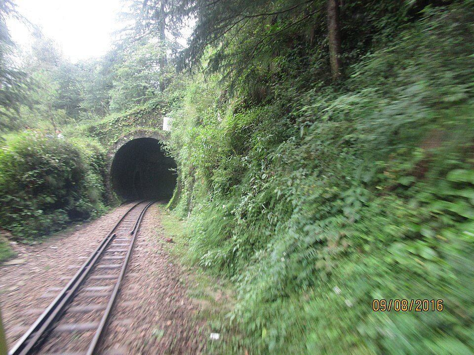 Historic Kalka-Shimla mountain railway train traversing high Himalayan foothills